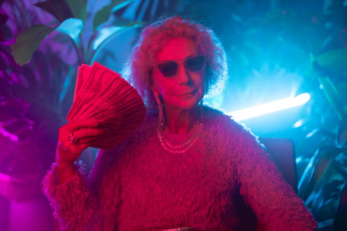 Photo of an elderly woman flaunting money